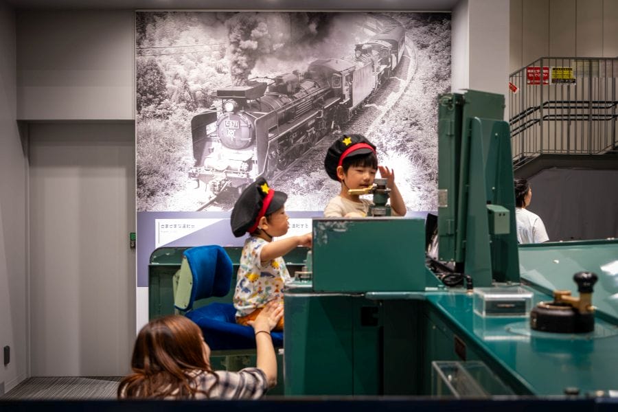 Kyoto Railway Museum children in caps playing