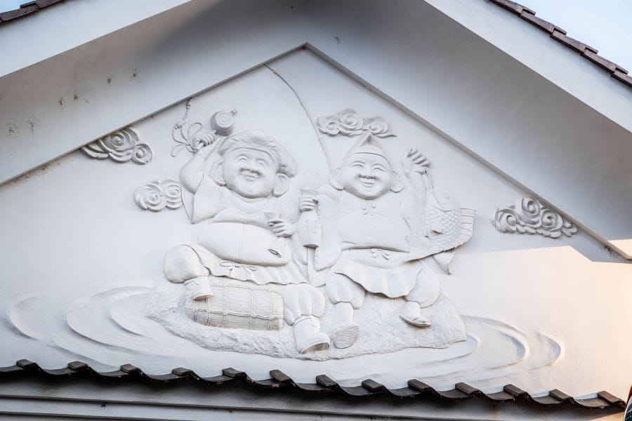 Saijo sake brewery district Daikoku and Ebisu plaster relief